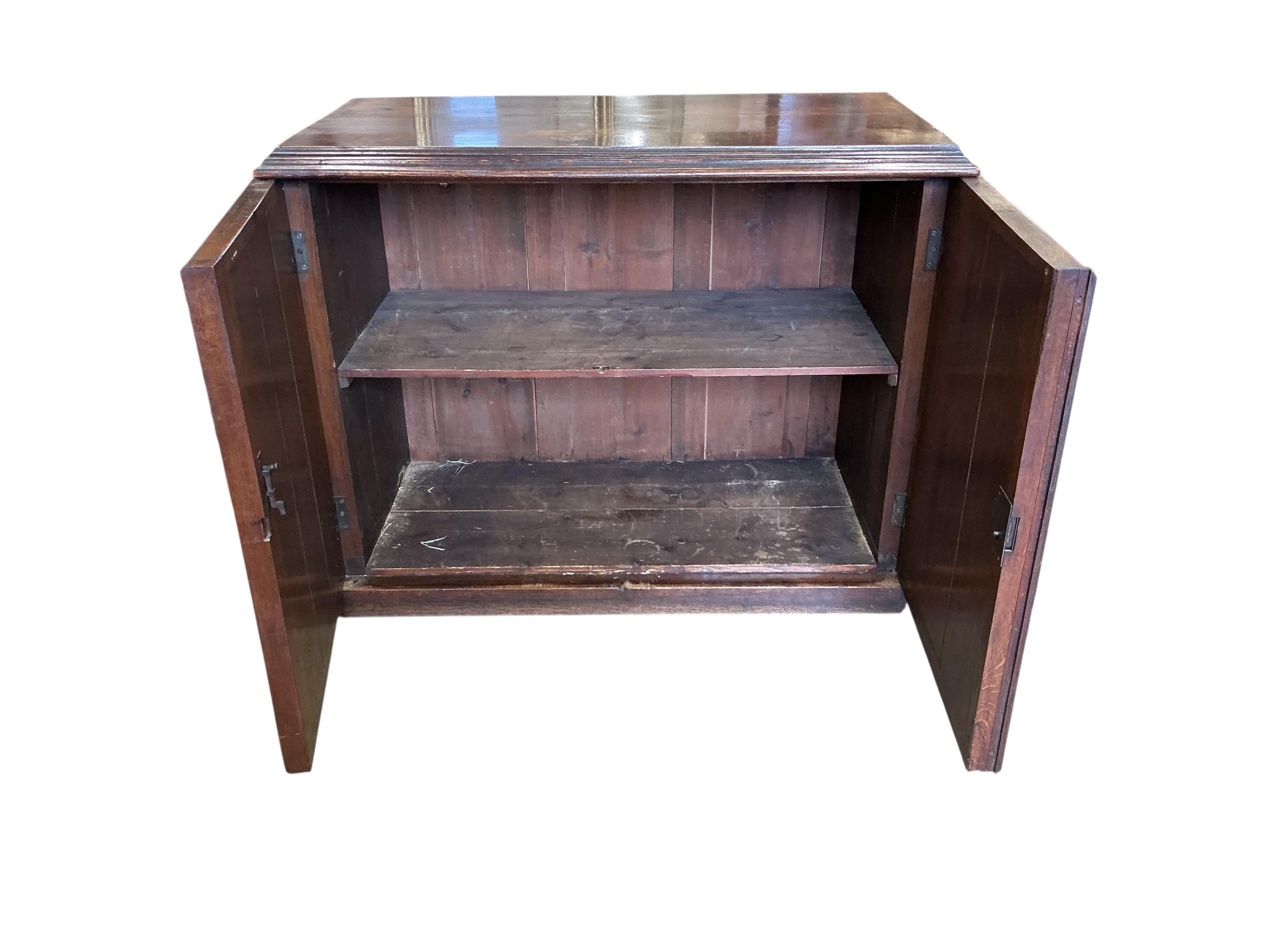 A late Victorian Gothic style oak two door side cabinet, width 122cm, depth 62cm, height 94cm